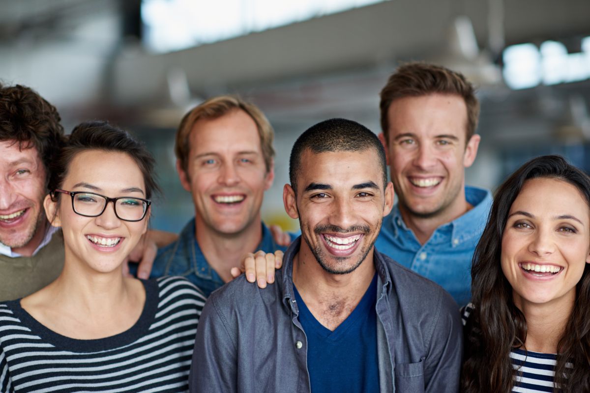 Positive work environment. Shot of a smiling group of coworkers standing in an office