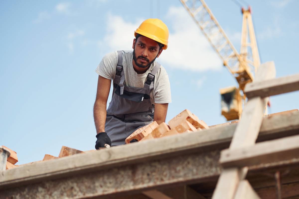 Focused on work. Handsome Indian man is on the construction site.