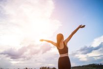 happy-smiling-athletic-woman-with-arms-outstretched-905x613