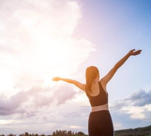 happy-smiling-athletic-woman-with-arms-outstretched-905x613