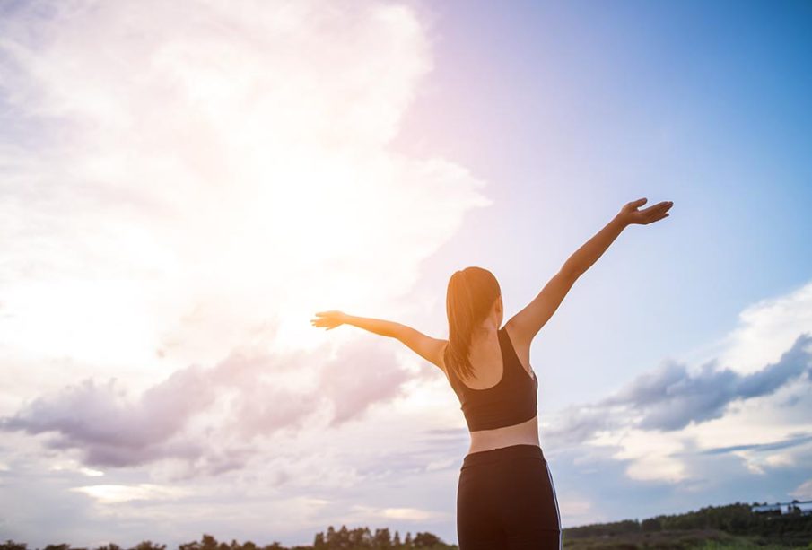 happy-smiling-athletic-woman-with-arms-outstretched-905x613