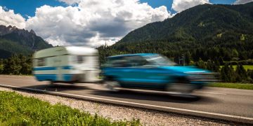 Family vacation travel, holiday trip in motorhome RV, Caravan car Vacation. Beautiful Nature Italy natural landscape Alps. Warning - authentic shooting there is a motion blur.