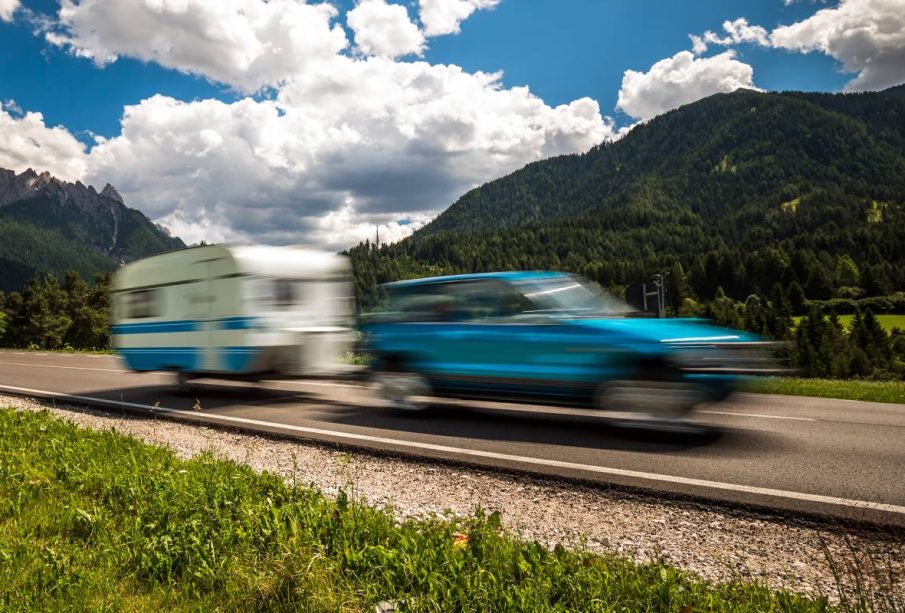 Family vacation travel, holiday trip in motorhome RV, Caravan car Vacation. Beautiful Nature Italy natural landscape Alps. Warning - authentic shooting there is a motion blur.