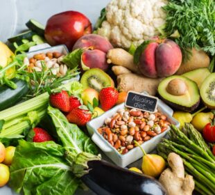 Balanced nutrition concept for clean eating alkaline diet. Assortment of healthy food ingredients for cooking on a kitchen table