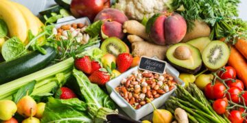 Balanced nutrition concept for clean eating alkaline diet. Assortment of healthy food ingredients for cooking on a kitchen table