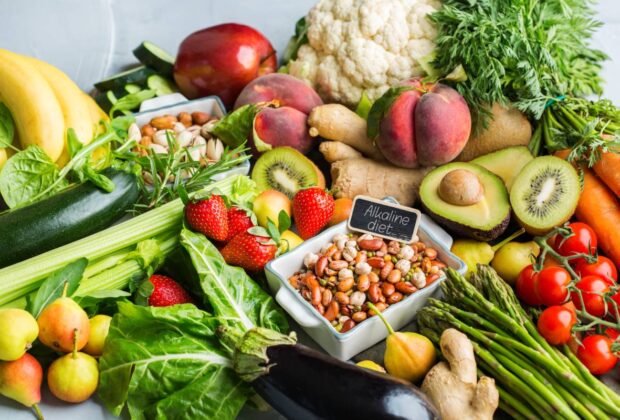 Balanced nutrition concept for clean eating alkaline diet. Assortment of healthy food ingredients for cooking on a kitchen table